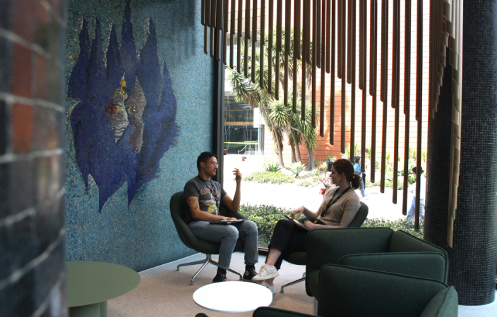 Two colleagues chatting at the Teaching Commons