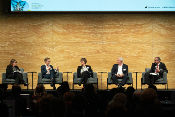 Panel members speaking at NSW HE Summit