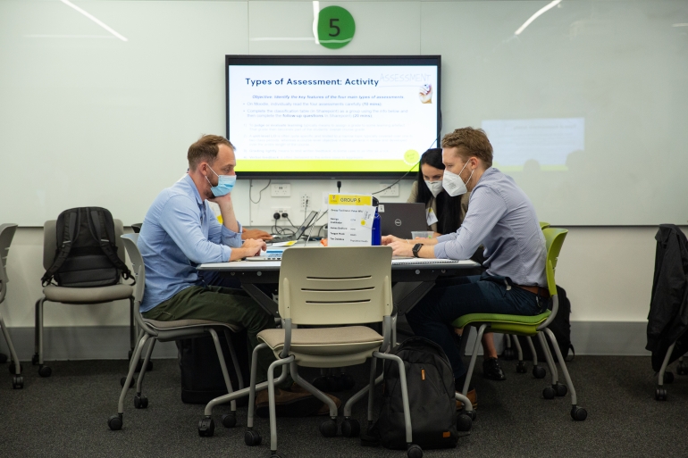 Course Design Institute: three people collaborating around table