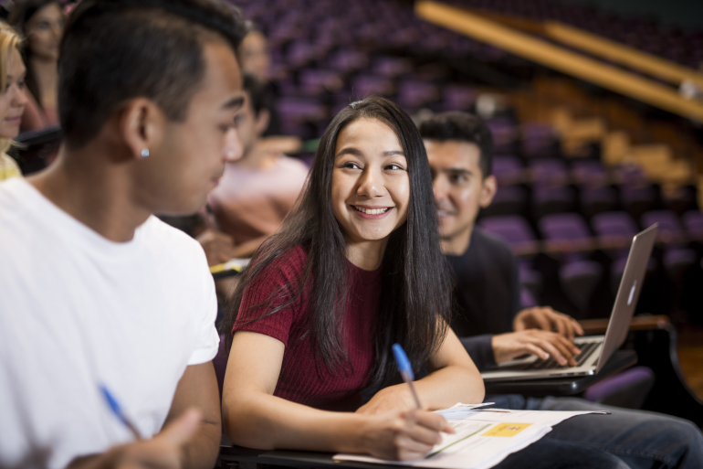 Student smiling in lecture theatre