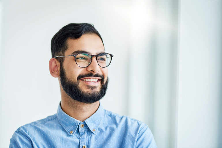 A man wearing glasses and smiling