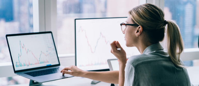 Woman using a computer looking at graphs