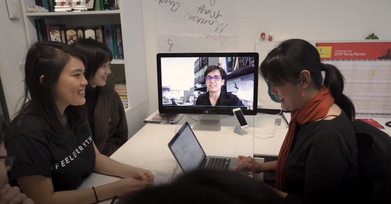 UNSW students and academic in front of a computer