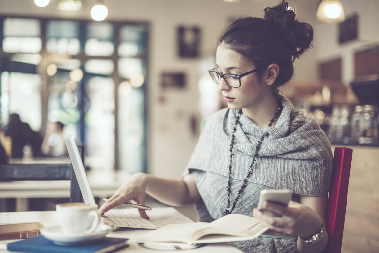 Female with laptop, mobile and coffee