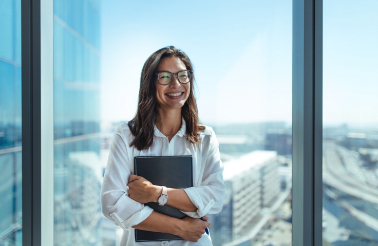 Women standing in front of office window