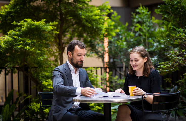 Two people talking outdoors