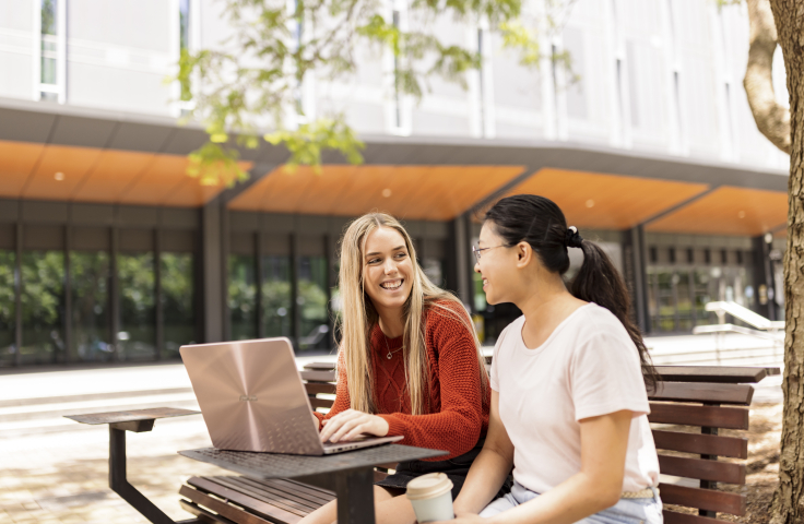 Students on campus looking at computer