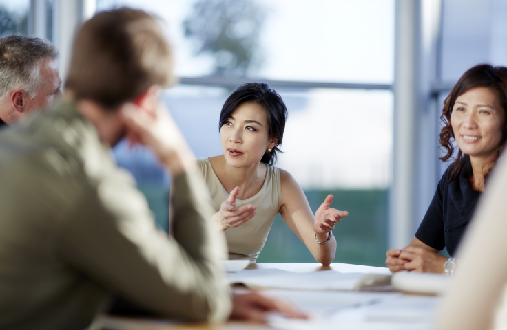 Academics chatting at a table