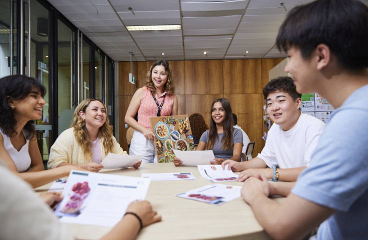 UNSW students gathered around table