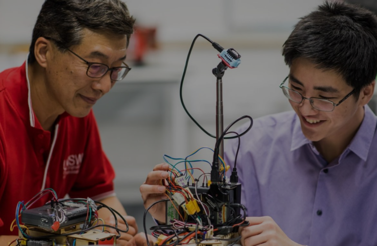 Student and teacher working on machine