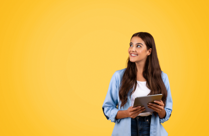 student with ipad smiling
