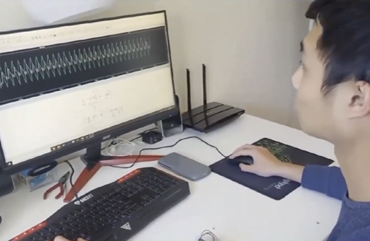 UNSW student in front of a computer with take-home lab equipment