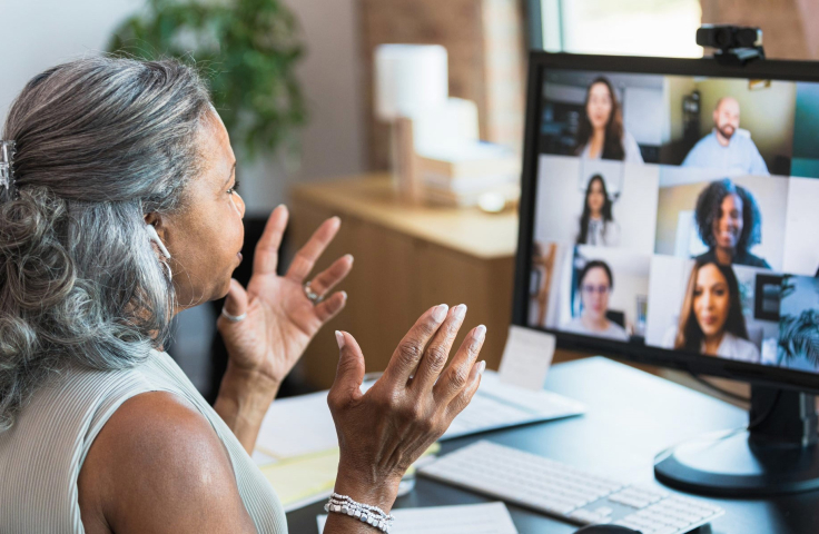 Woman speaking with colleagues over online meeting
