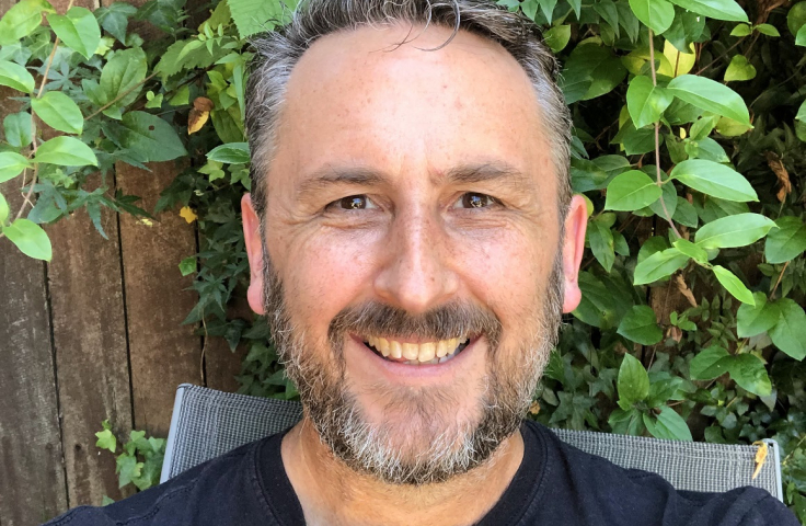 Mike Bogle in front of green leaves