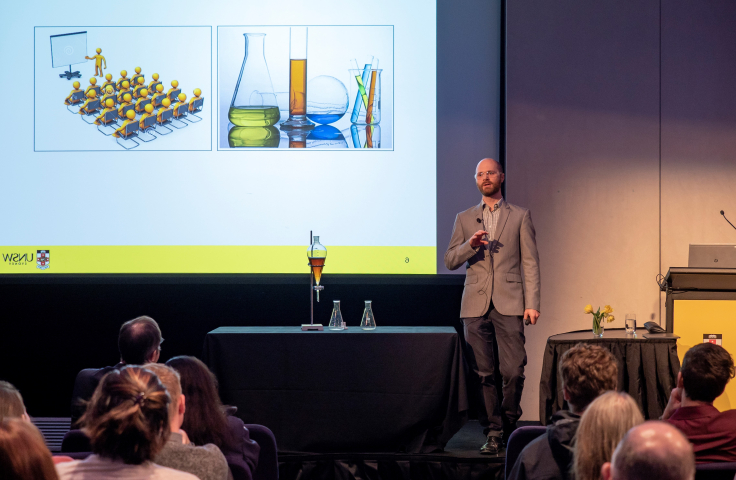 man presenting a lecture to people